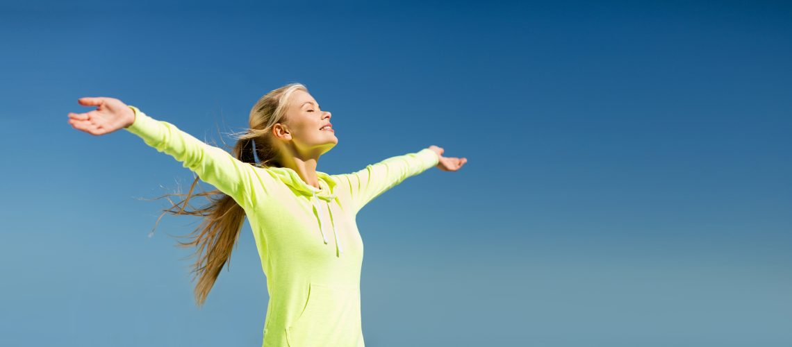 sport, fitness, exercise and lifestyle concept - woman doing sports outdoors